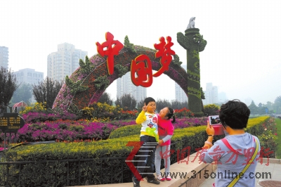 市民在復興門橋“放飛夢想”花壇前留念。昨天,長安街沿線花壇擺放工作全部完成。京華時報記者徐曉帆攝